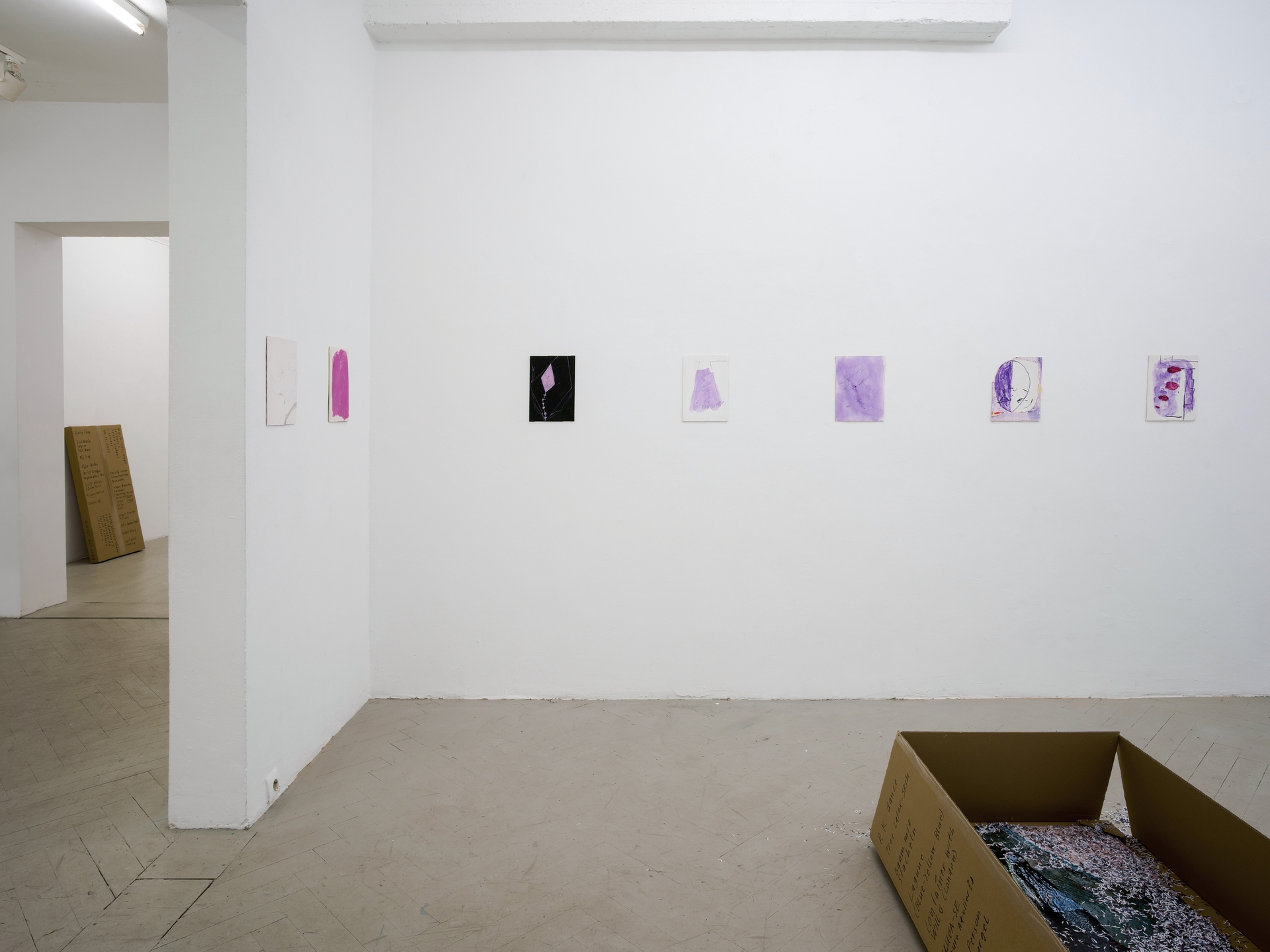 Flying Carpet Shop exhibition view, multiple Amphoras artworks displayed, detail of cardboard boxes and encrypted inscriptions